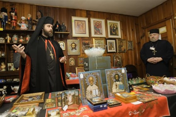 Archbishop Timothy Kjera, left, and Father Anthony Luebke show the gift shop run by the Syro Russian Orthodox Catholic Church at the Monastery Inn in Canfield, Ohio, on March 2.